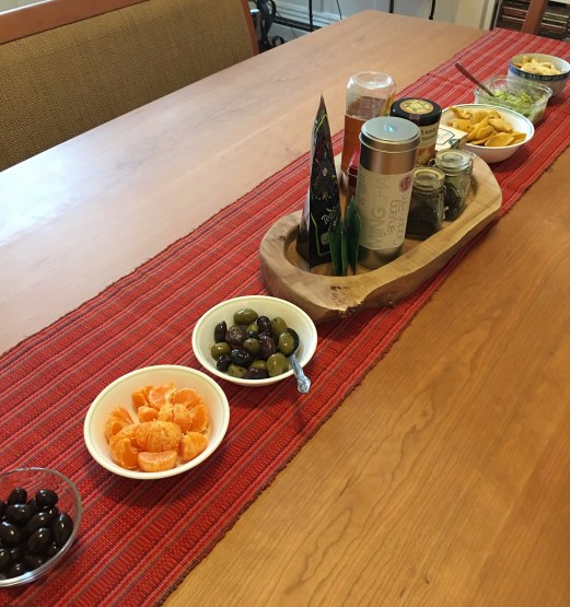 Dark chocolate almonds, clementines, olives, guacamole, corn chips, banana chips, and an assortment of teas