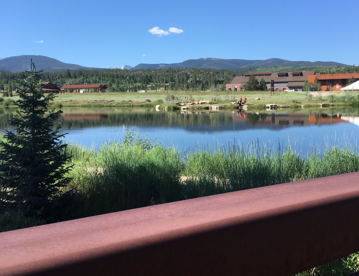 Fraser Park Trail in Colorado - view of the mountains and pond from the bridge