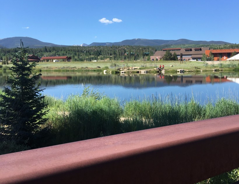 Fraser Park Trail in Colorado - view of the mountains and pond from the bridge